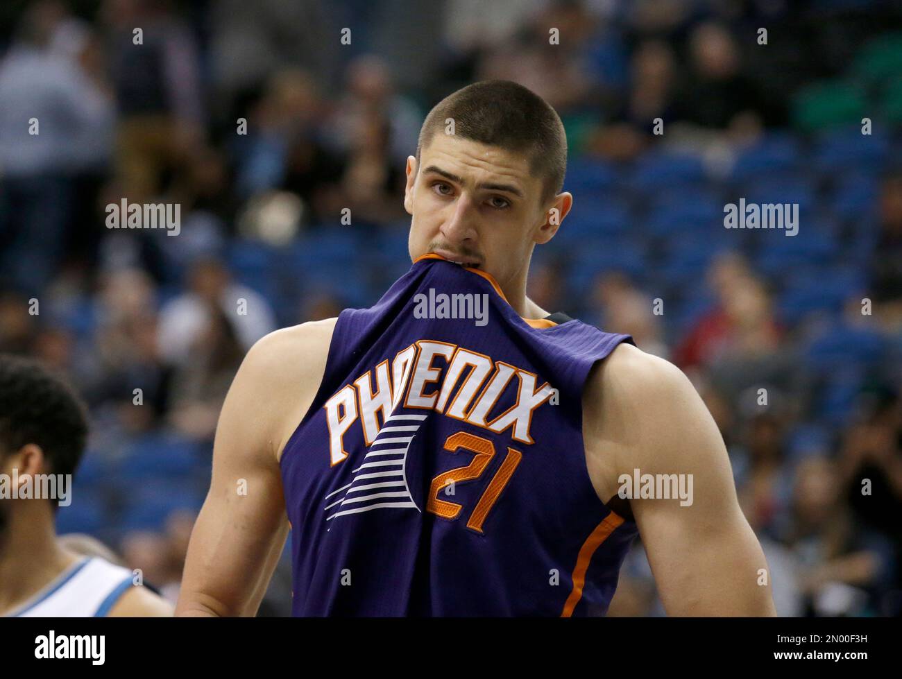 Phoenix Suns center Alex Len (21) bites his jersey during the second half of an NBA basketball game against the Minnesota Timberwolves in Minneapolis, Monday, March 28, 2016