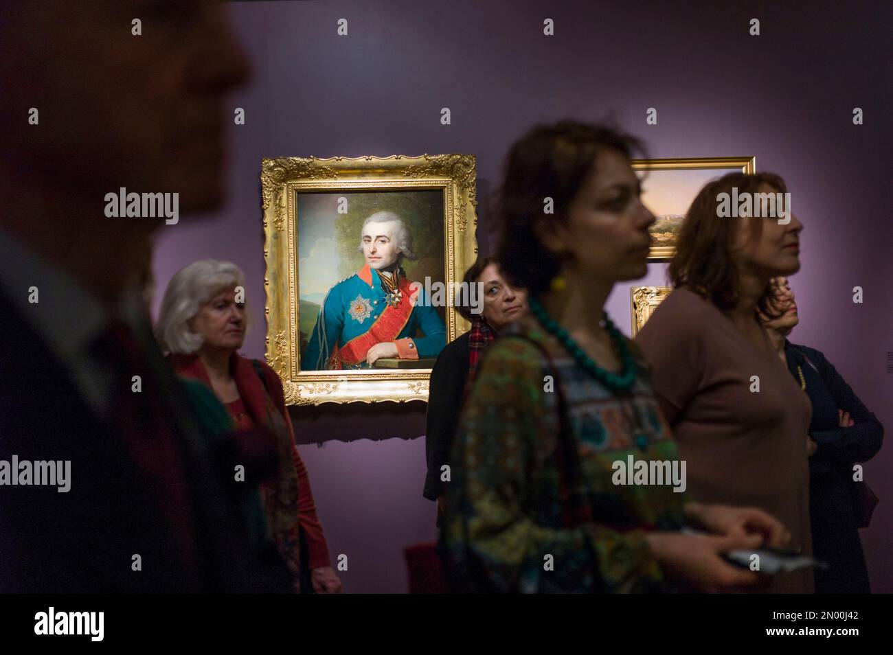 Visitors study paintings from the Ilya Silberstein Collection of the