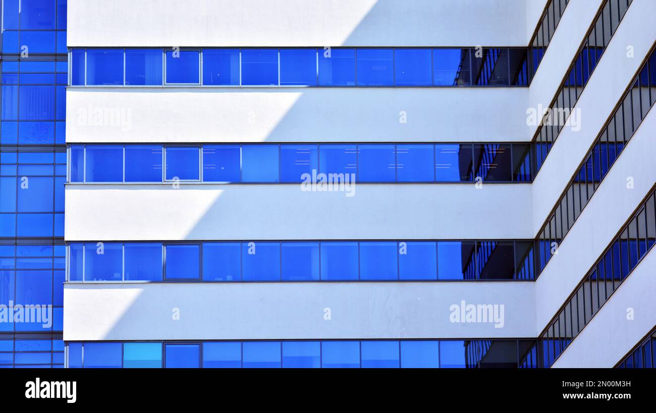 Glass building with transparent facade of the building and blue sky ...