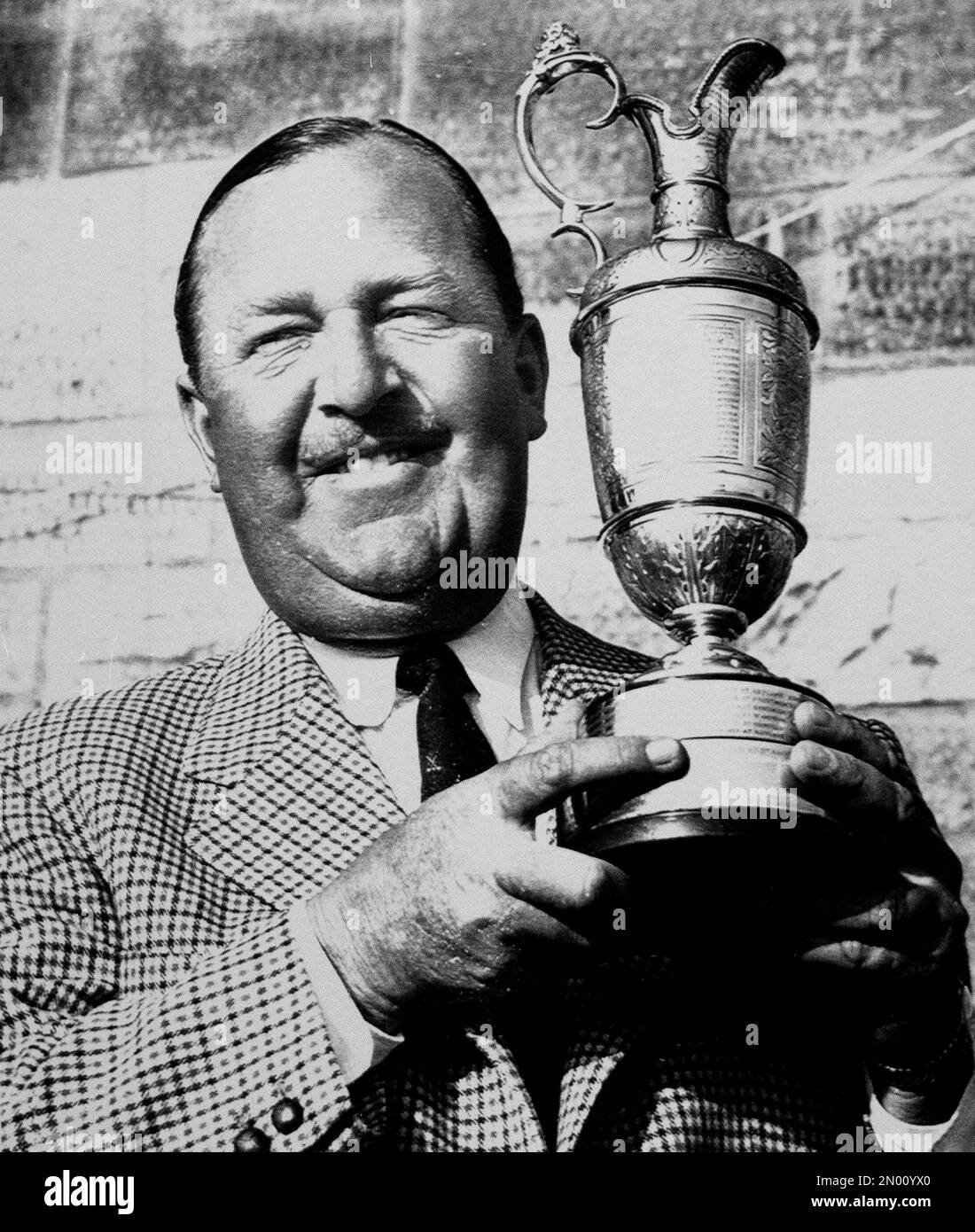 Veteran South African golfer Bobby Locke holds the 1957 British Open