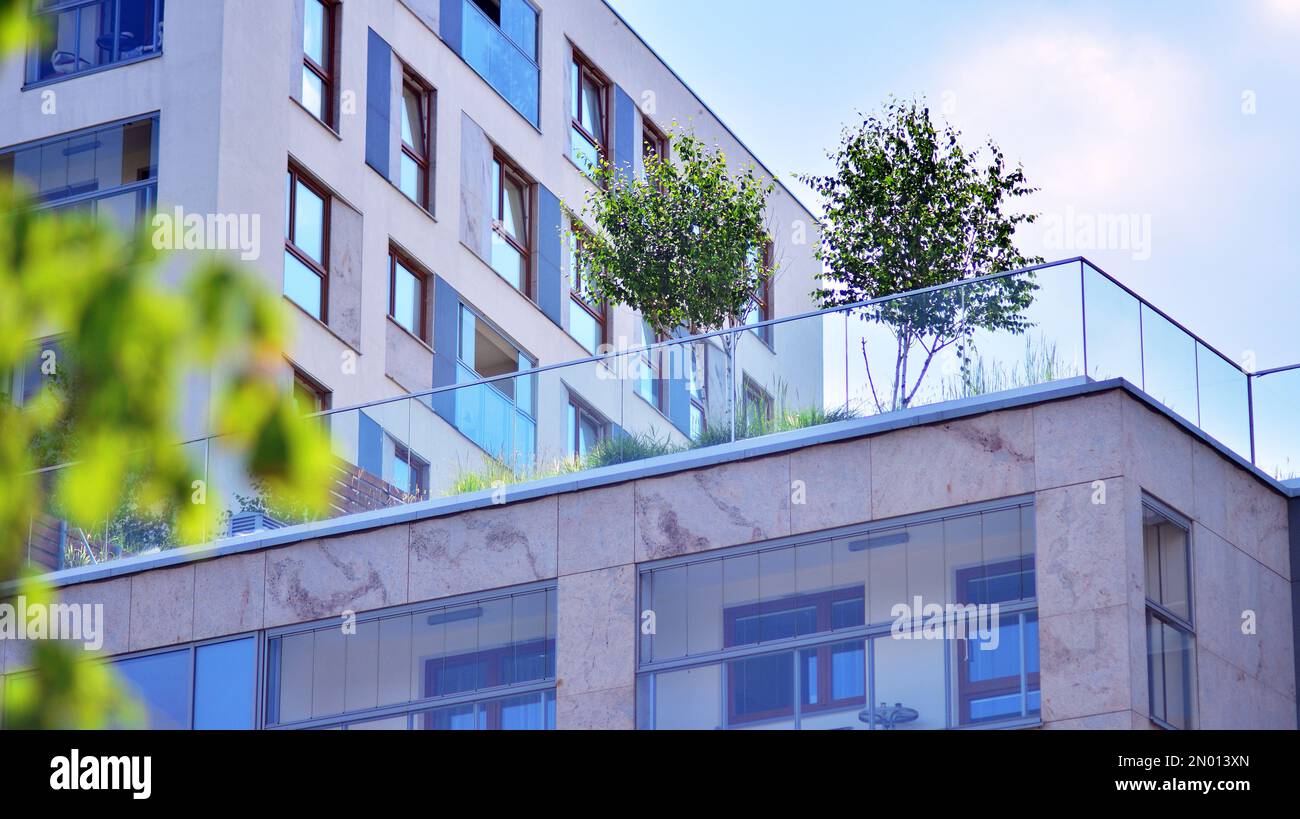 Modern residential building with new apartments in a green residential ... - Green Apartment Renovations Costs Uk