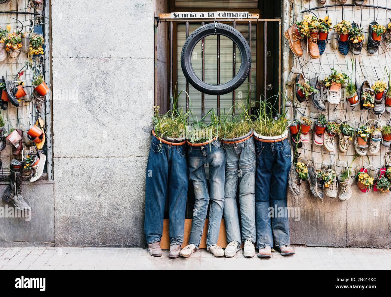 general view of original planters made of jeans. In the photo there is a  sign that says "Smile for the camera Stock Photo - Alamy
