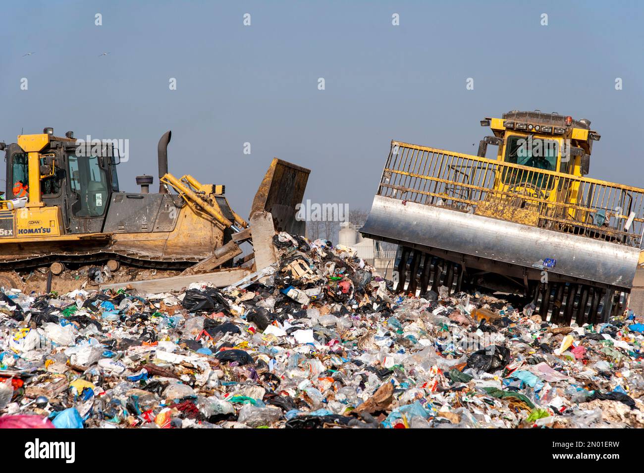 Municipal waste landfill. Workers with trucks and bulldozers at work in