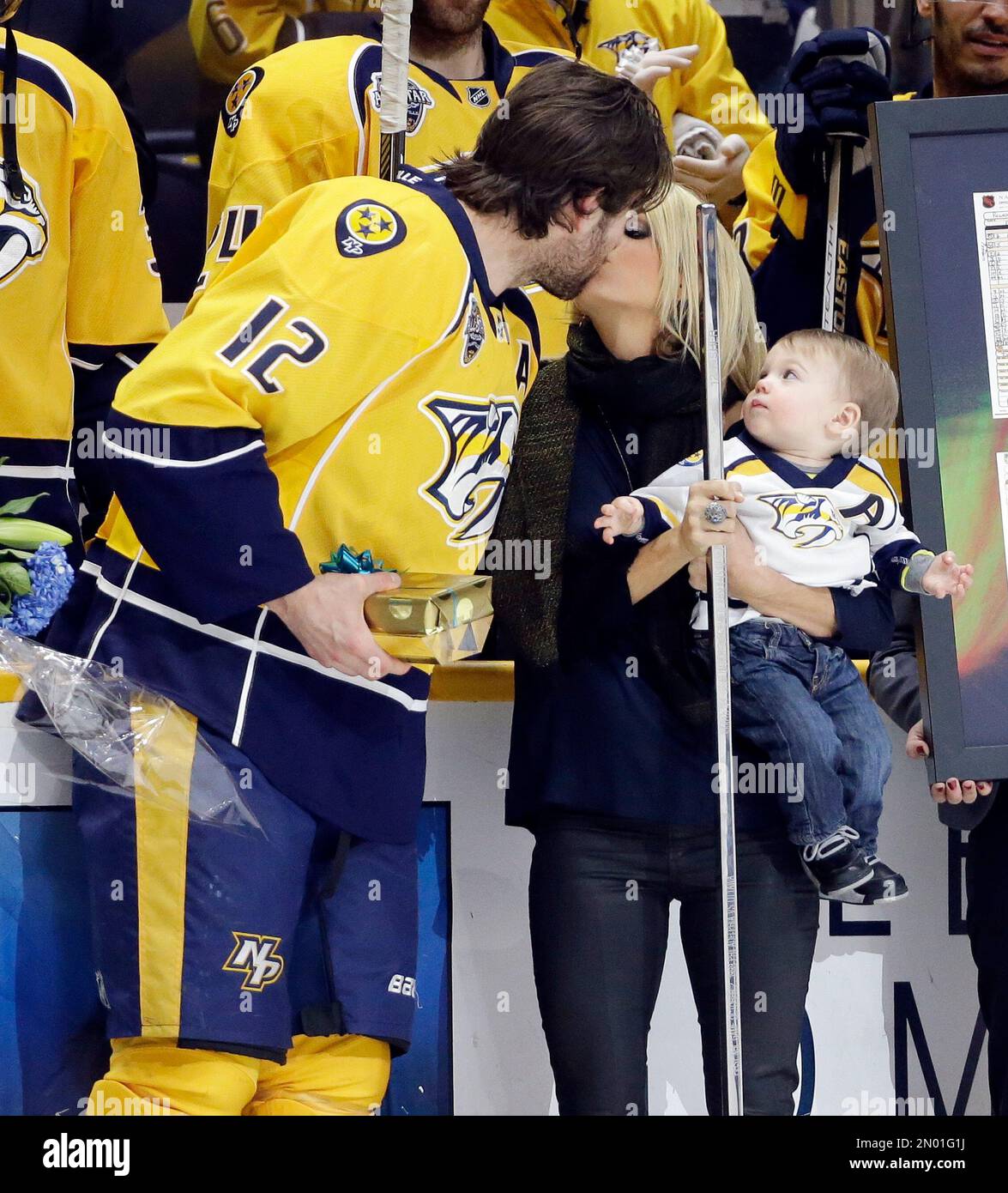 Nashville Predators forward Mike Fisher kisses his wife, singer Carrie
