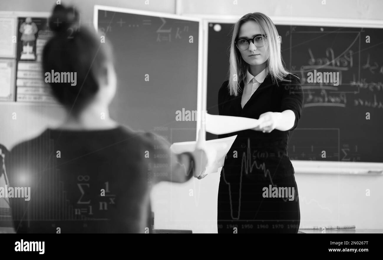 young-girl-teacher-in-primary-school-in-class-in-front-of-blackboard