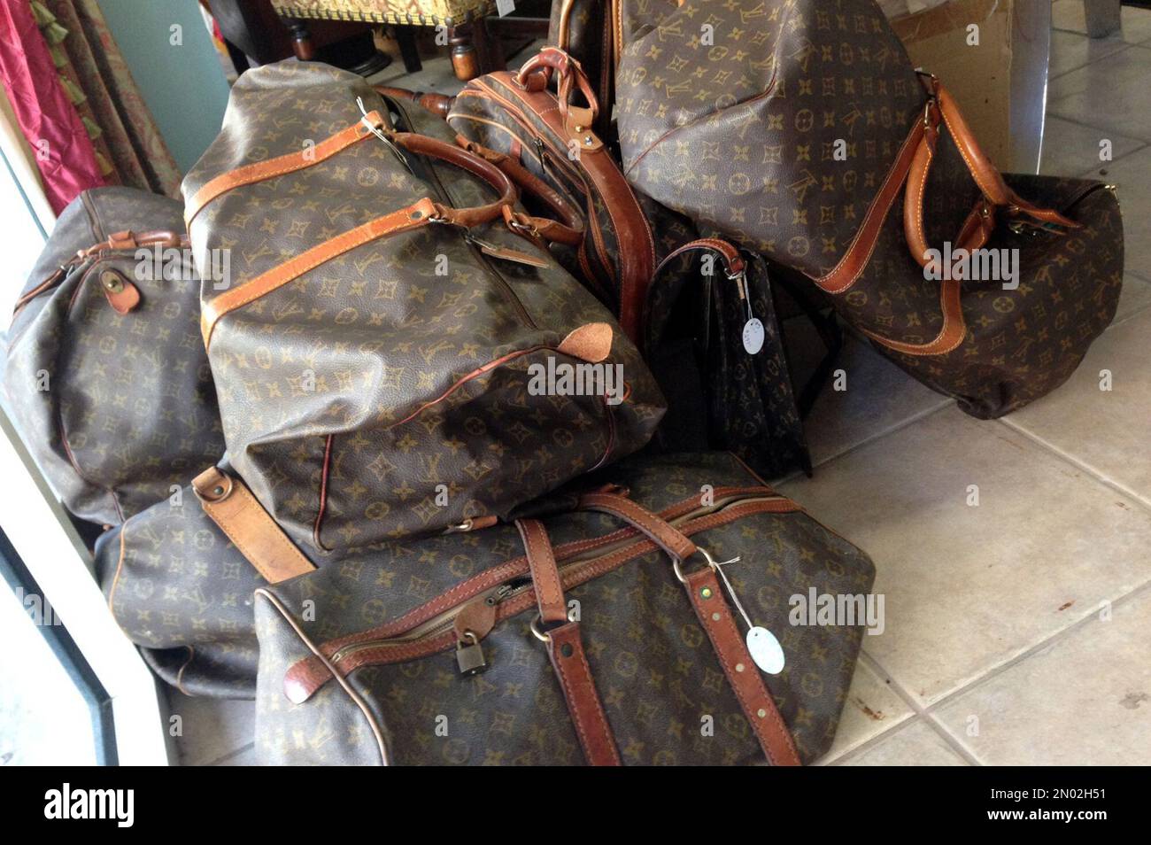 In this Feb. 25, 2016 photo, a variety of Louis Vuitton bags are seen at  the Paradise Lost consignment store in Palm Beach, Fla. The island's busy  society calendar means twice-daily costume