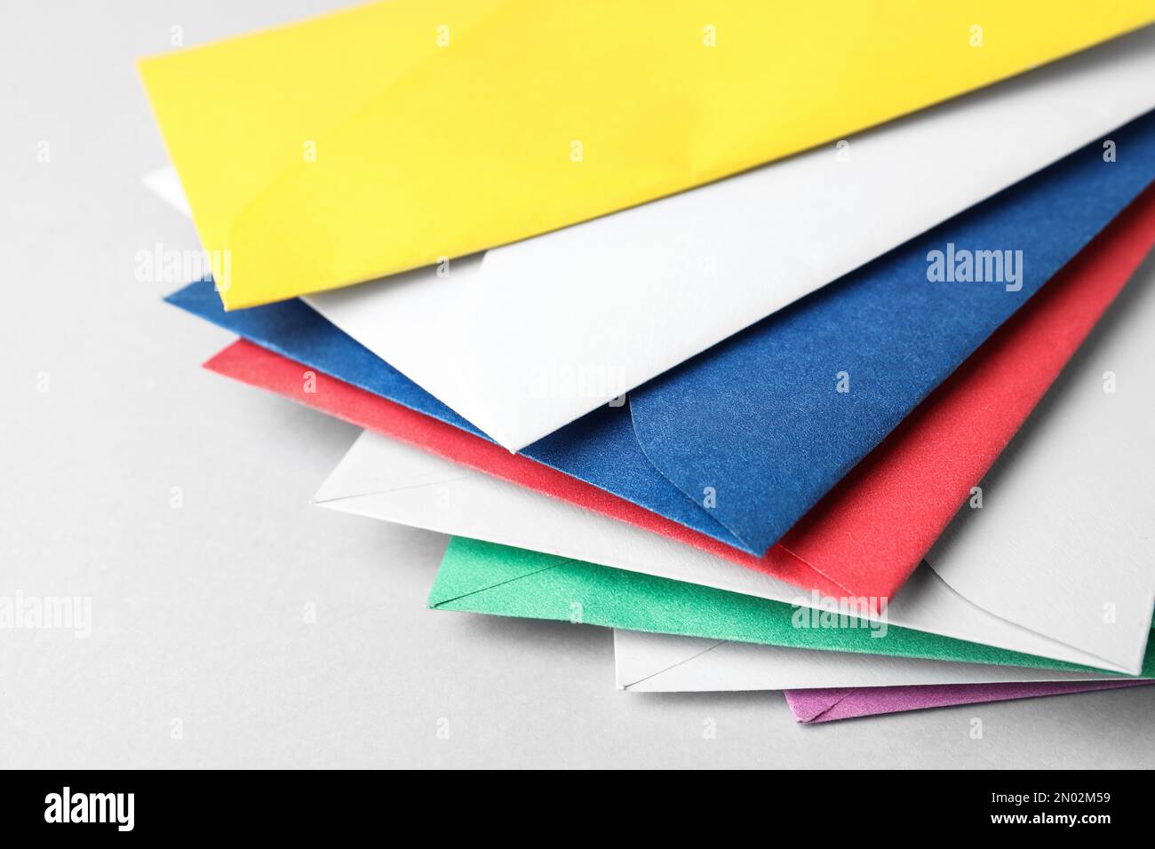 Colorful paper envelopes on light background, closeup Stock Photo