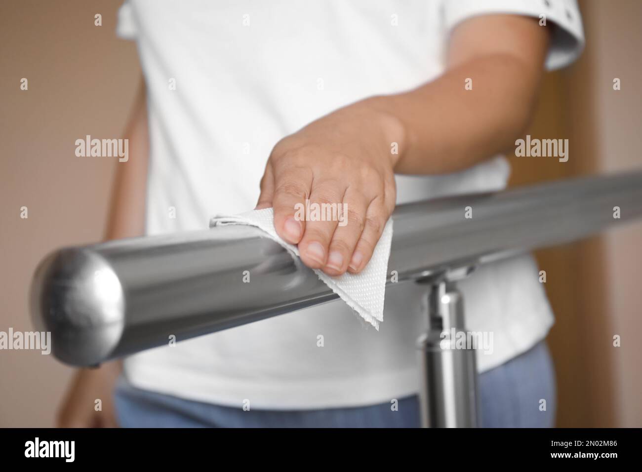Woman cleaning metal railing with tissue paper, closeup Stock Photo Alamy