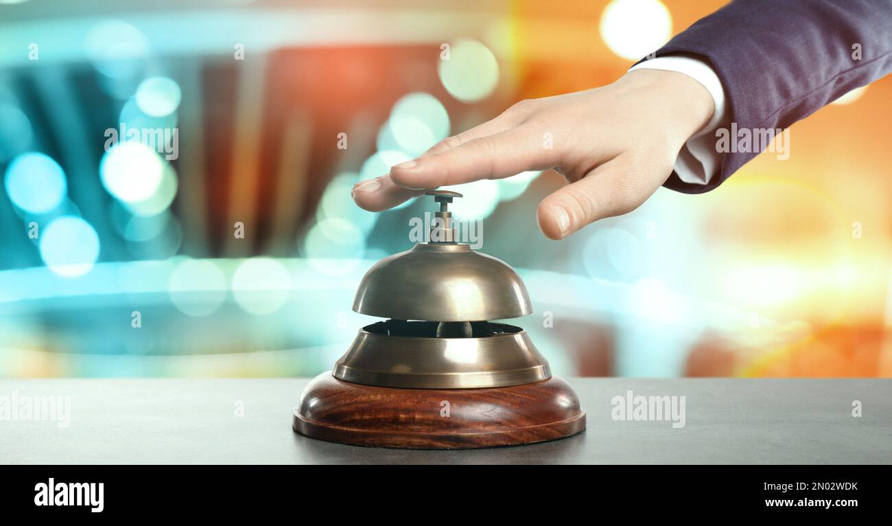 Man ringing hotel service bell on blurred background, closeup. Banner design  Stock Photo - Alamy