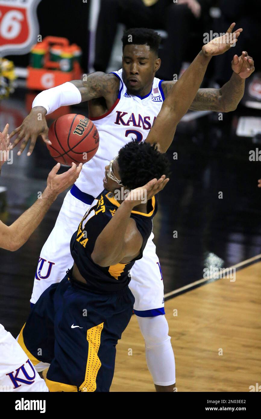 Kansas forward Jamari Traylor (31) strips the ball from West Virginia  forward Devin Williams (41) during the second half of an NCAA college  basketball game in the finals of the Big 12