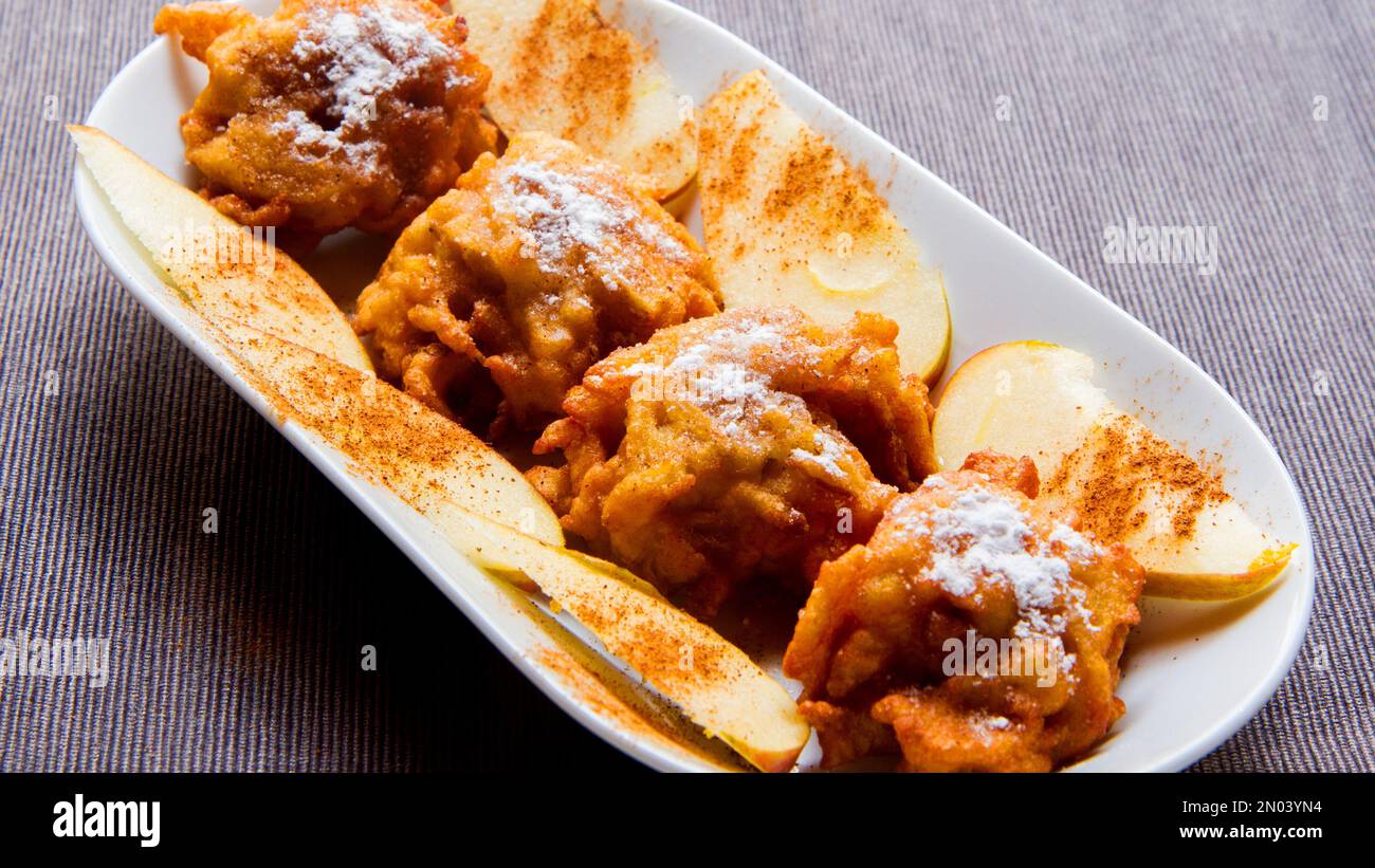 Fritters prepared with flour and apple. Traditional Spanish recipe Stock Photo