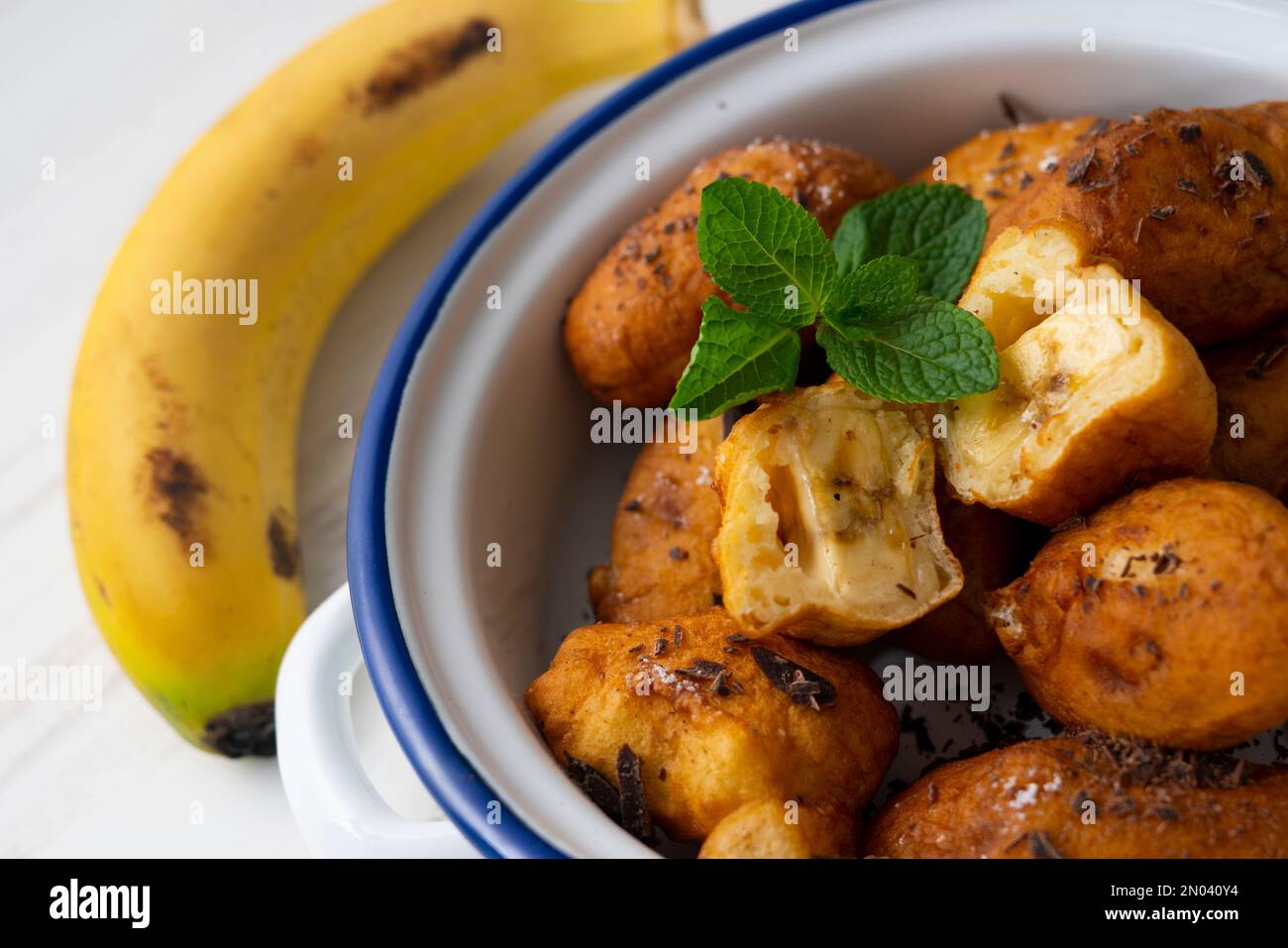 Fritters prepared with flour and banana. Traditional Spanish recipe Stock Photo