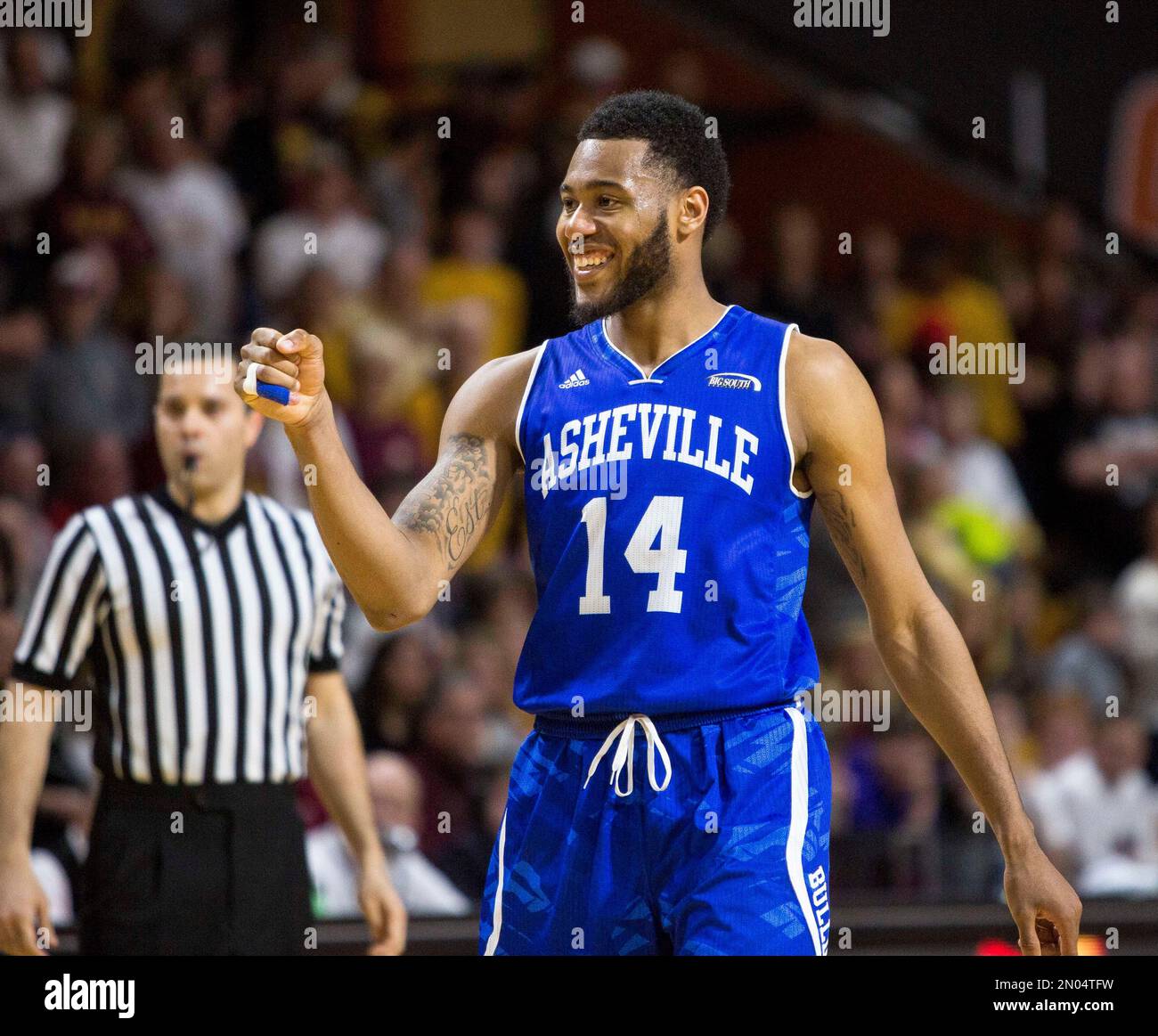 UNC Asheville’s Ahmad Thomas (14) smiles at a teammate during the second half of an NCAA college