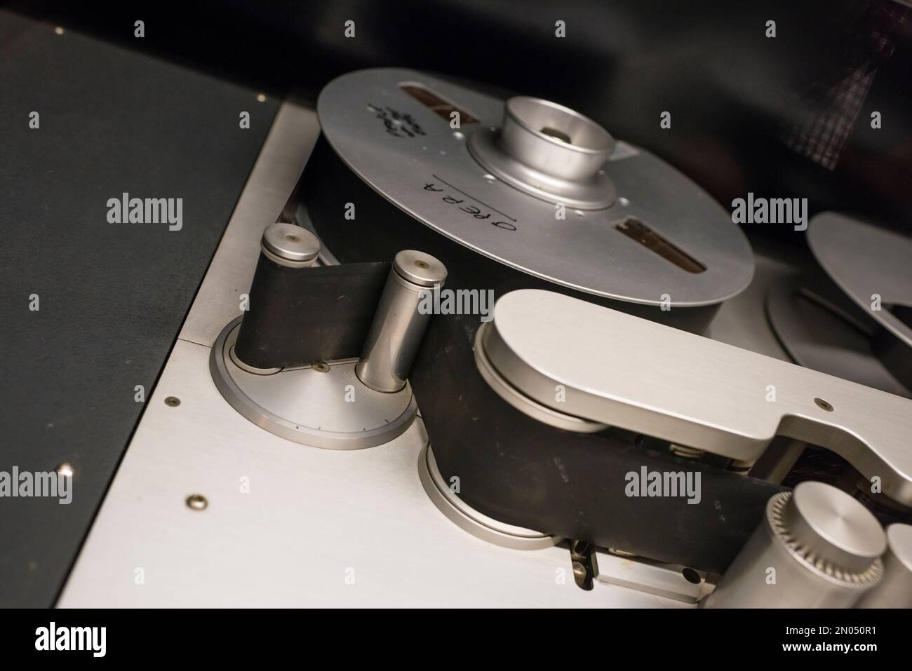 Vintage analog audio recording tape and other sound equipment in a professional music recording studio Stock Photo