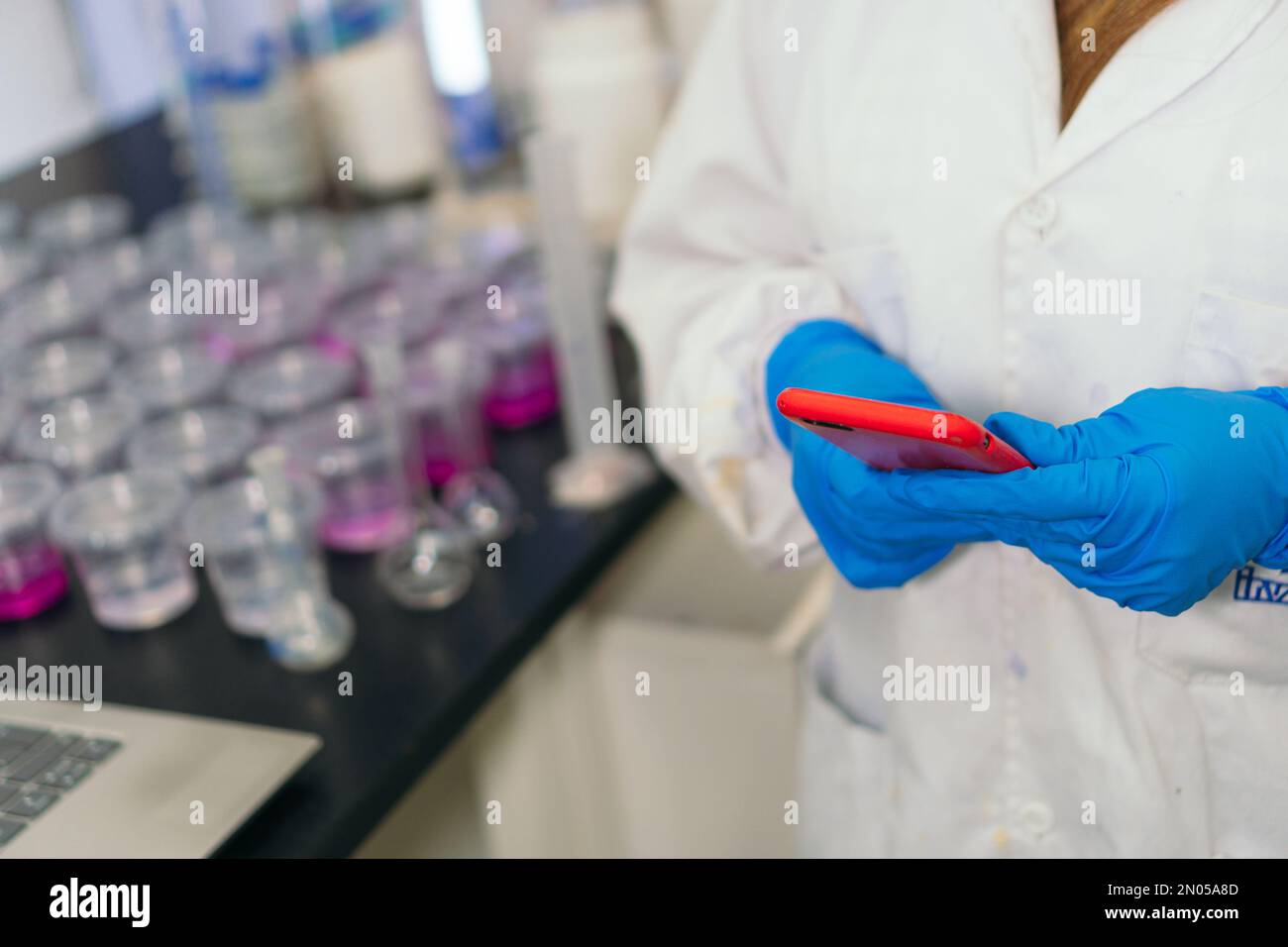 Close-up of a researcher using a phone in a laboratory. Stock Photo