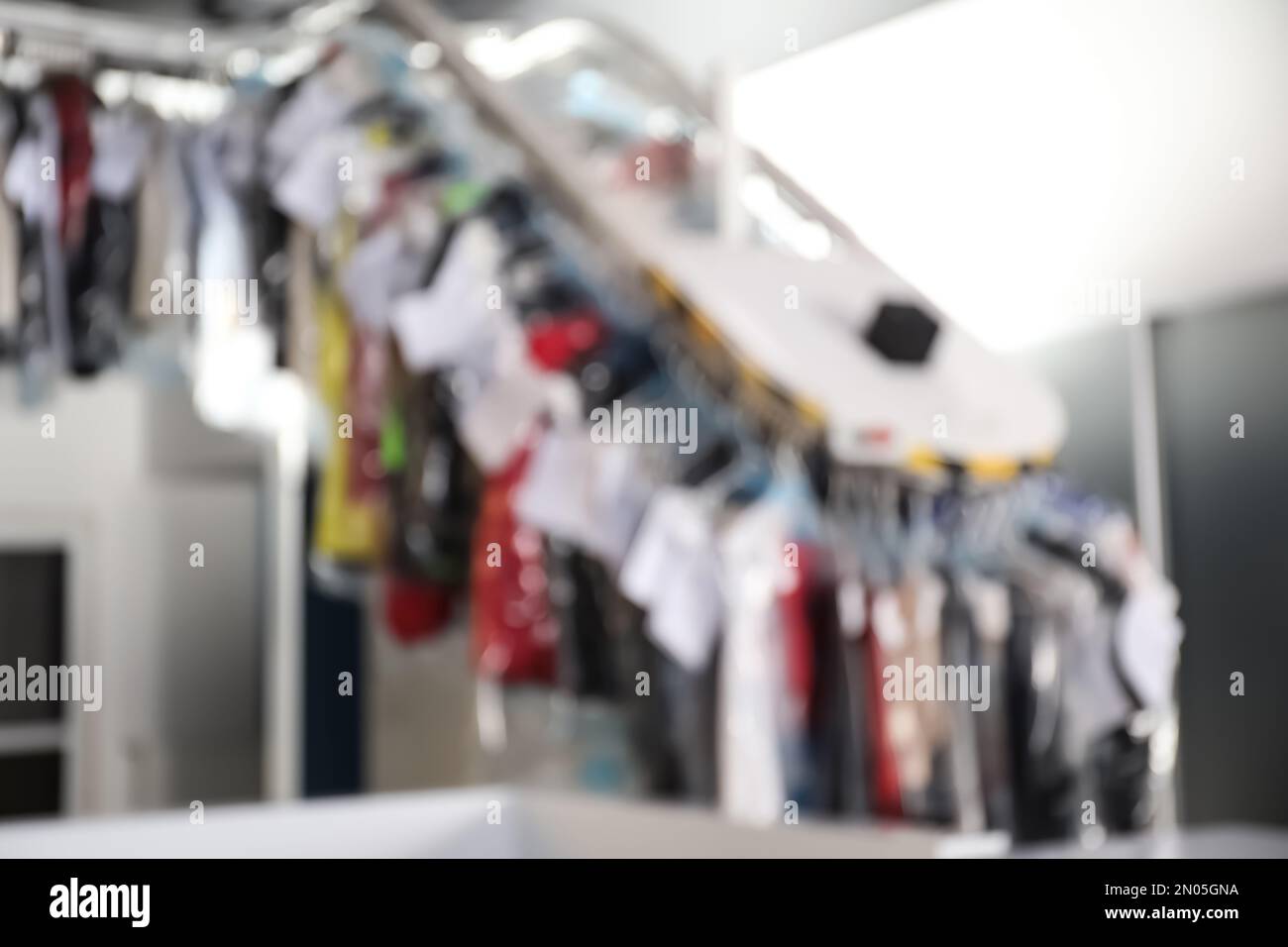 Blurred view of dry-cleaner's interior with garment conveyor Stock ...