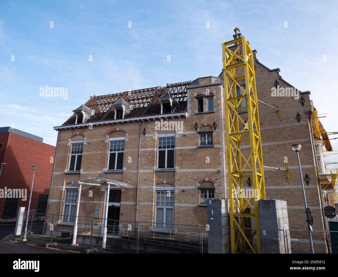 Demolition works begin with the roof of a large housing complex Stock Photo