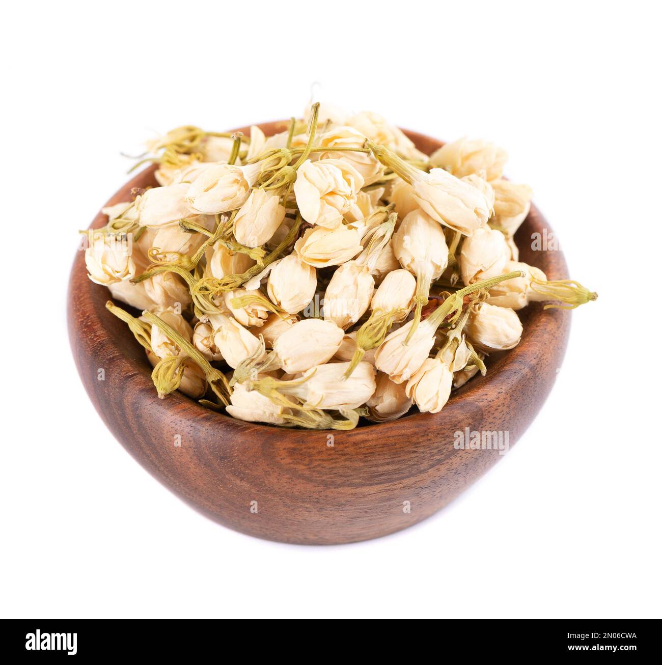 Dry jasmine flowers in wooden bowl, isolated on white background. Jasmine flowers tea. Herbal