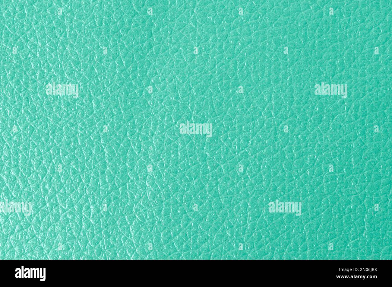 Texture of genuine grainy leather of light mint green color for wallpaper or banner design. Fashionable modern background, copy space Stock Photo