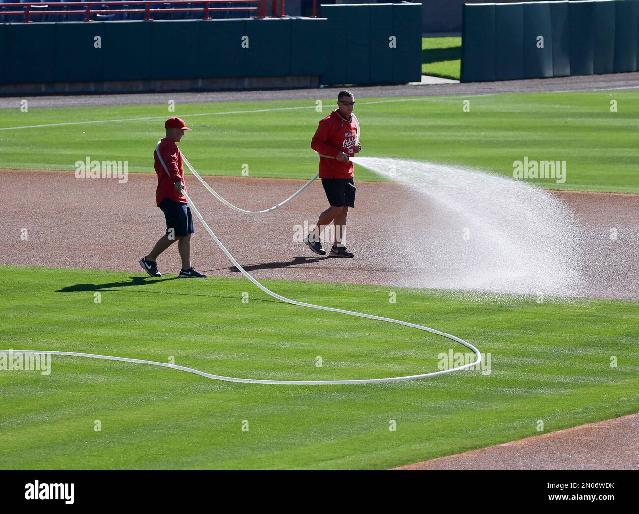 Washington Nationals grounds crew sprays water on the infield base path  before an intrasquad baseball game at a spring training workout, Sunday,  Feb. 28, 2016, in Viera, Fla. (AP Photo/John Raoux Stock