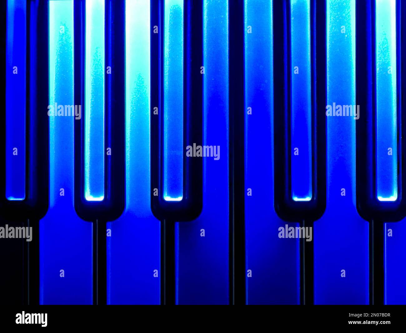 a detail of a colourful, illuminated, computer music, midi keyboard