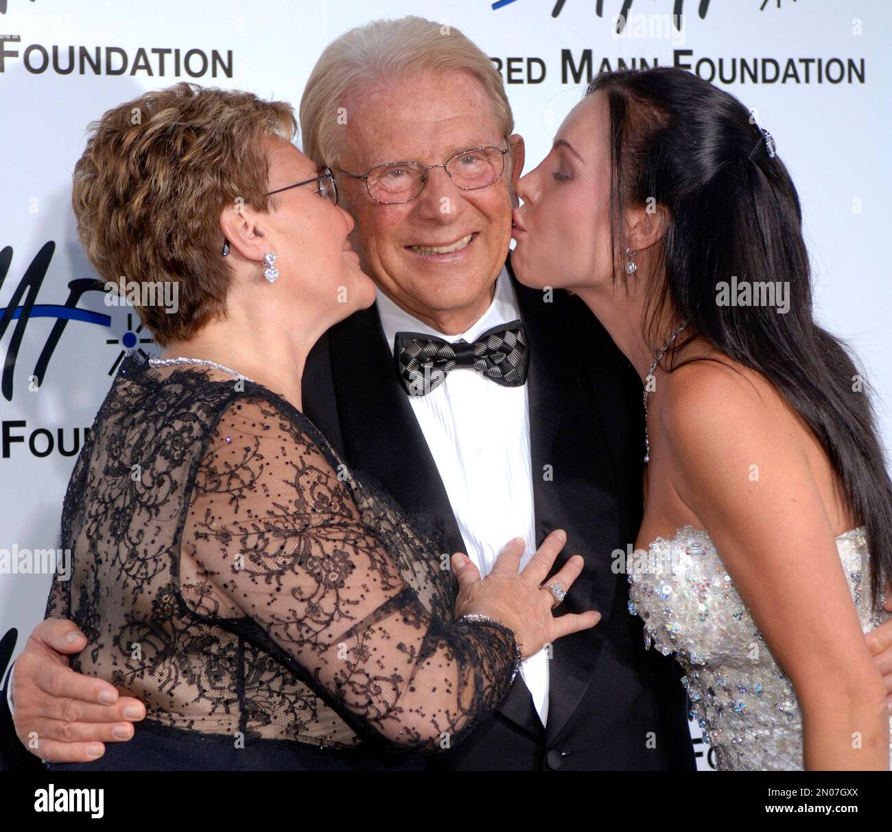 FILE - In this Sept. 9, 2006 file photo, Alfred E. Mann poses with his wife  Claude Mann, left, and daughter Cassandra Mann at the third annual Alfred  Mann Foundation Innovation and