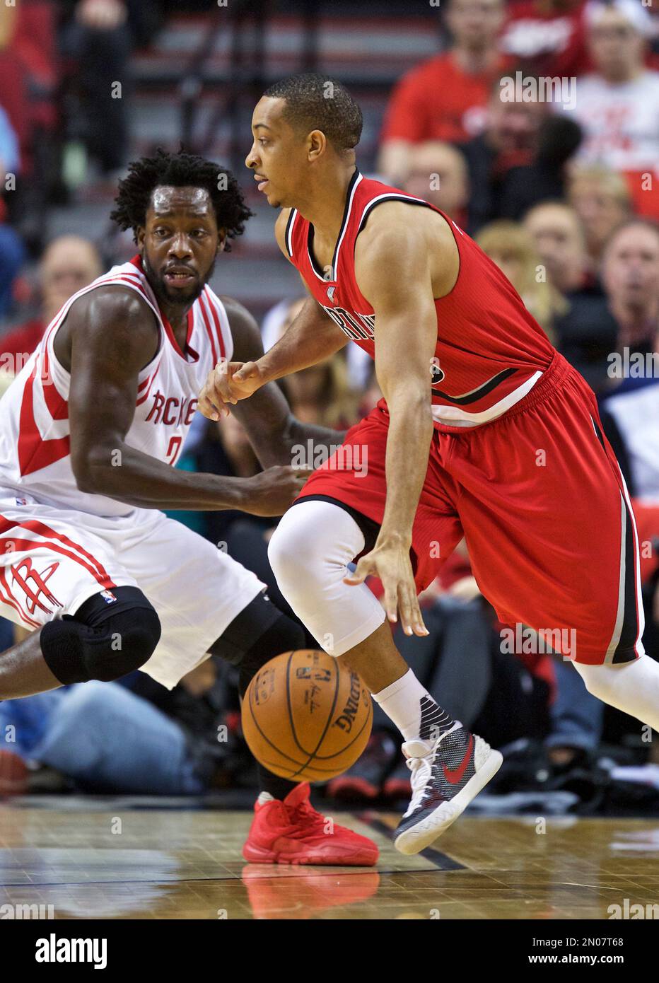 Portland Trail Blazers guard C.J. McCollum, right, dribbles past