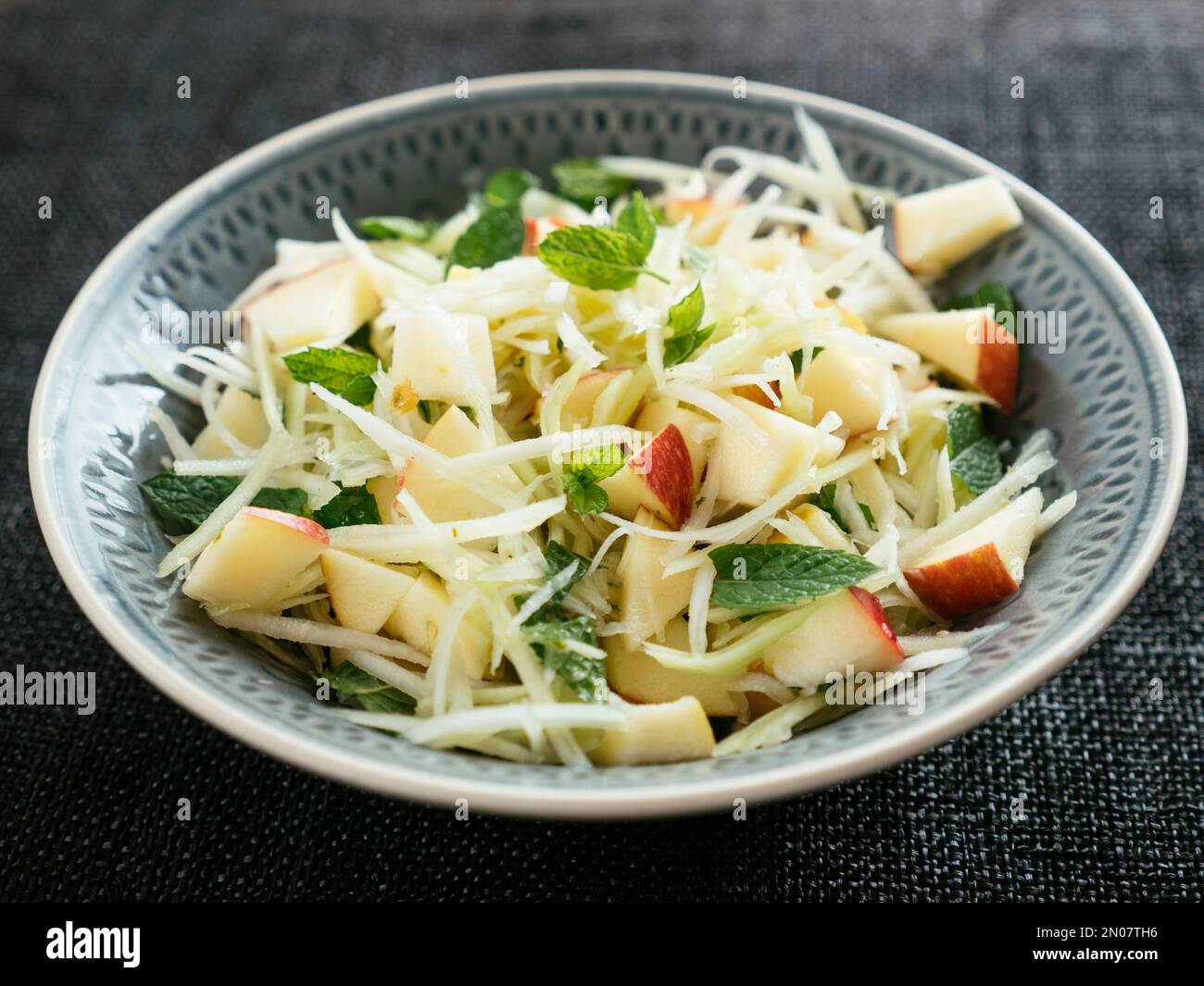 Home made Kohlrabi and Apple Slaw with Mint in a bowl Stock Photo