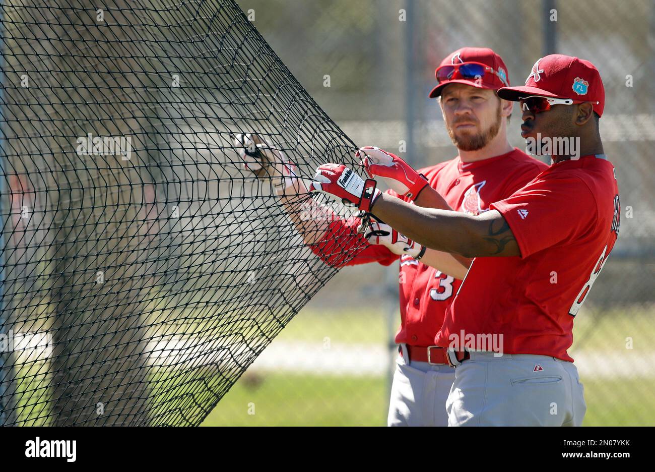 St. Louis Cardinals' Brandon Moss, left, and Anthony Garcia help keep