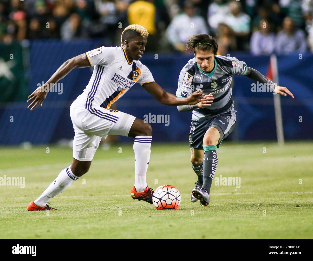 Santos Laguna midfielder Jorge Flores Villafana, left, and Los Angeles  Galaxy forward Gyasi Zardes in actions during the first half of a CONCACAF  Champions League quarterfinal in Carson, Calif., Wednesday, Feb. 24,