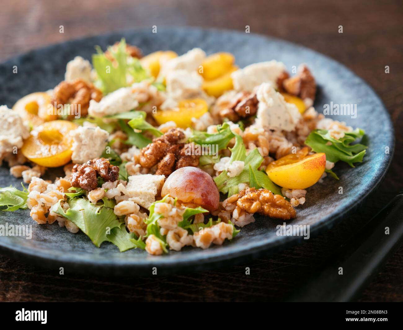 Farro Salad with Mirabelle Plums, Vegan Feta and Spicy Walnuts Stock Photo