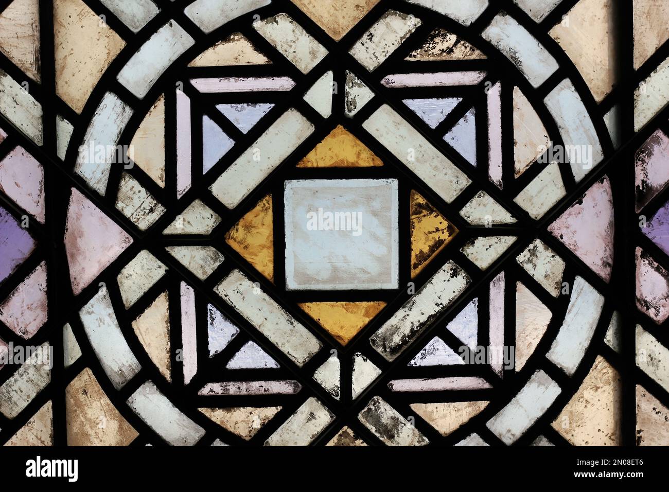 Geometric shapes of a beautiful medieval stained glass window Stock