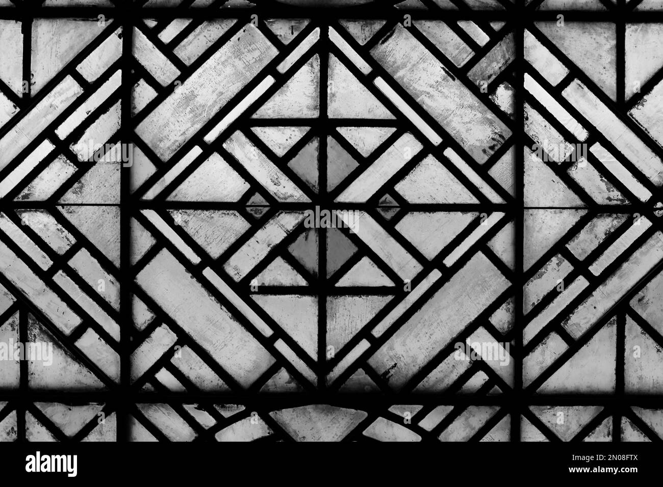 Geometric shapes of a beautiful medieval stained glass window in a