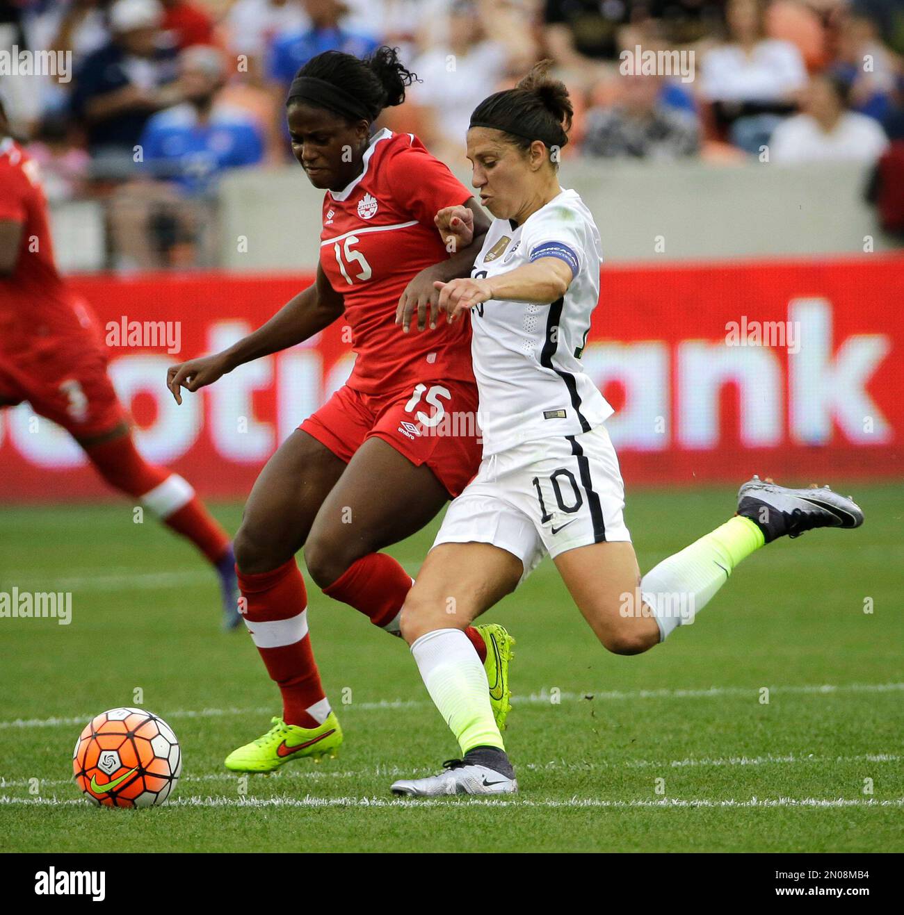United States’ Carli Lloyd (10) challenges Canada's Nichelle Prince (15