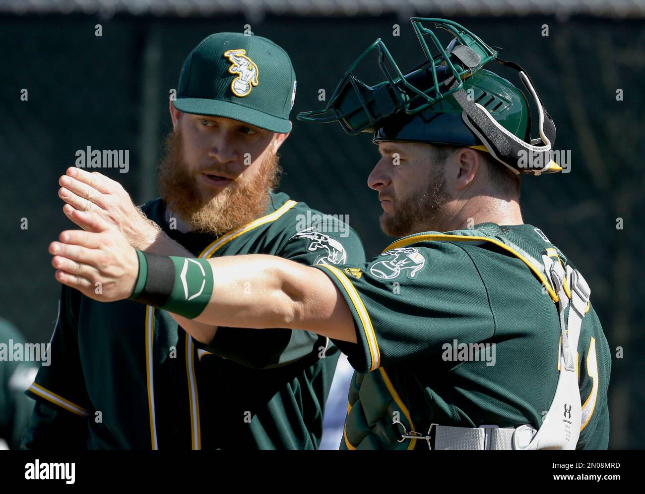 Oakland Athletics catcher Stephen Vogt, right, works with relief