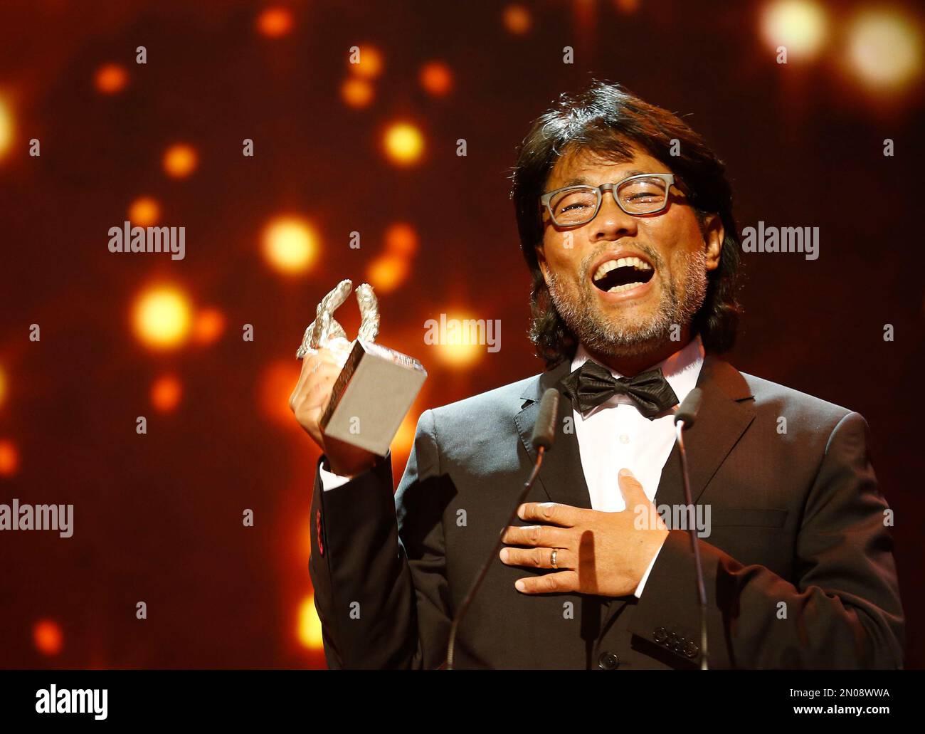 Mark Lee Ping-Bing, cameraman for 'Chang Jiang Tu', displays his award ...