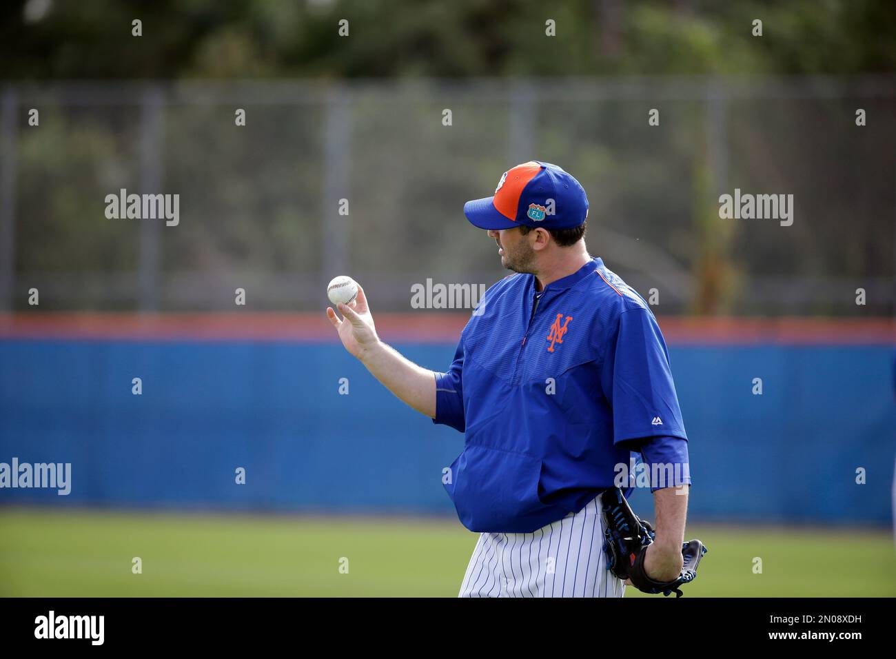 New York Mets pitcher Matt Harvey looks at a ball during spring