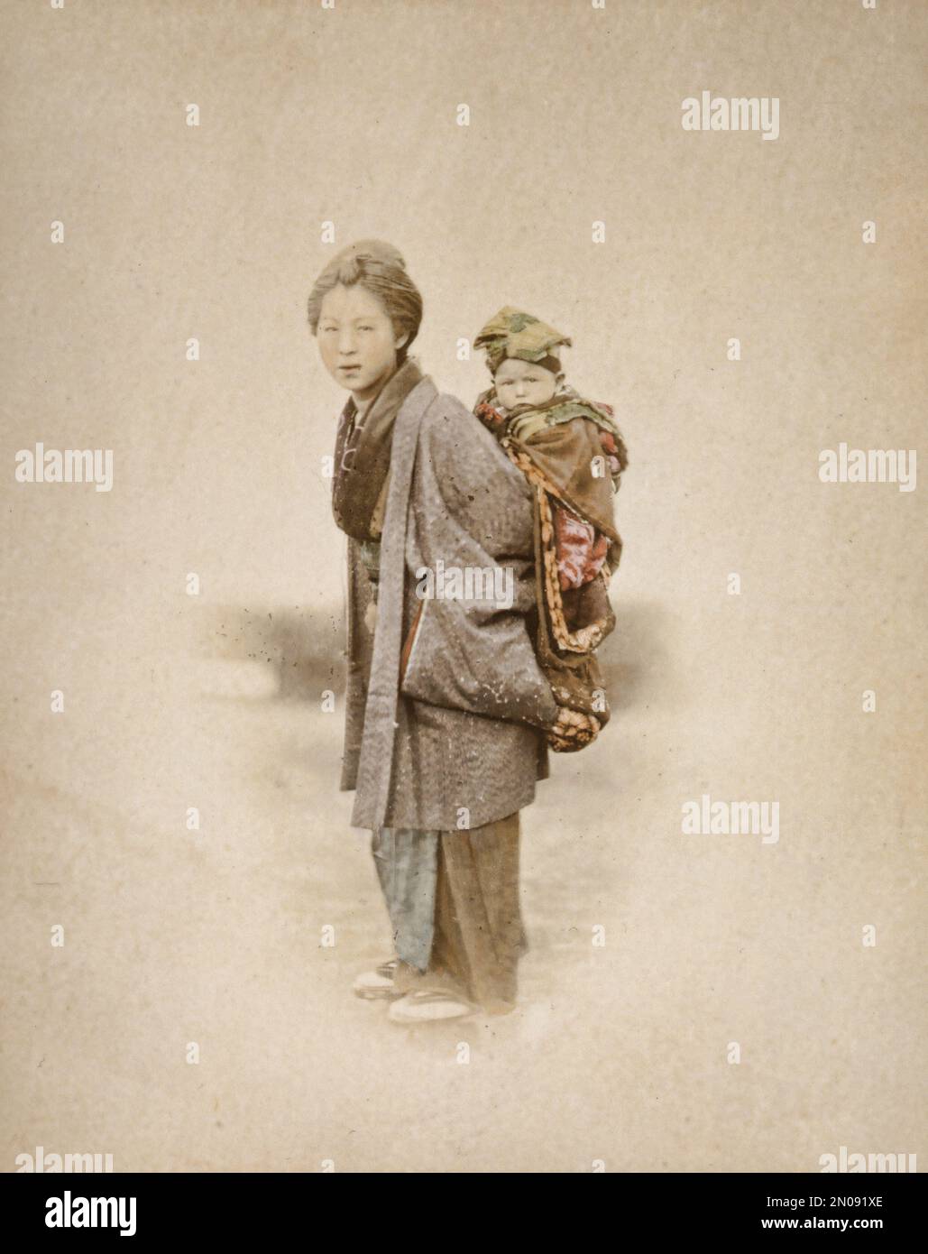 A photograph of a Japanese mother and child, published in Views & Costumes of Japan by Stillfried and Andersen (Yokohama, 1877). Stock Photo