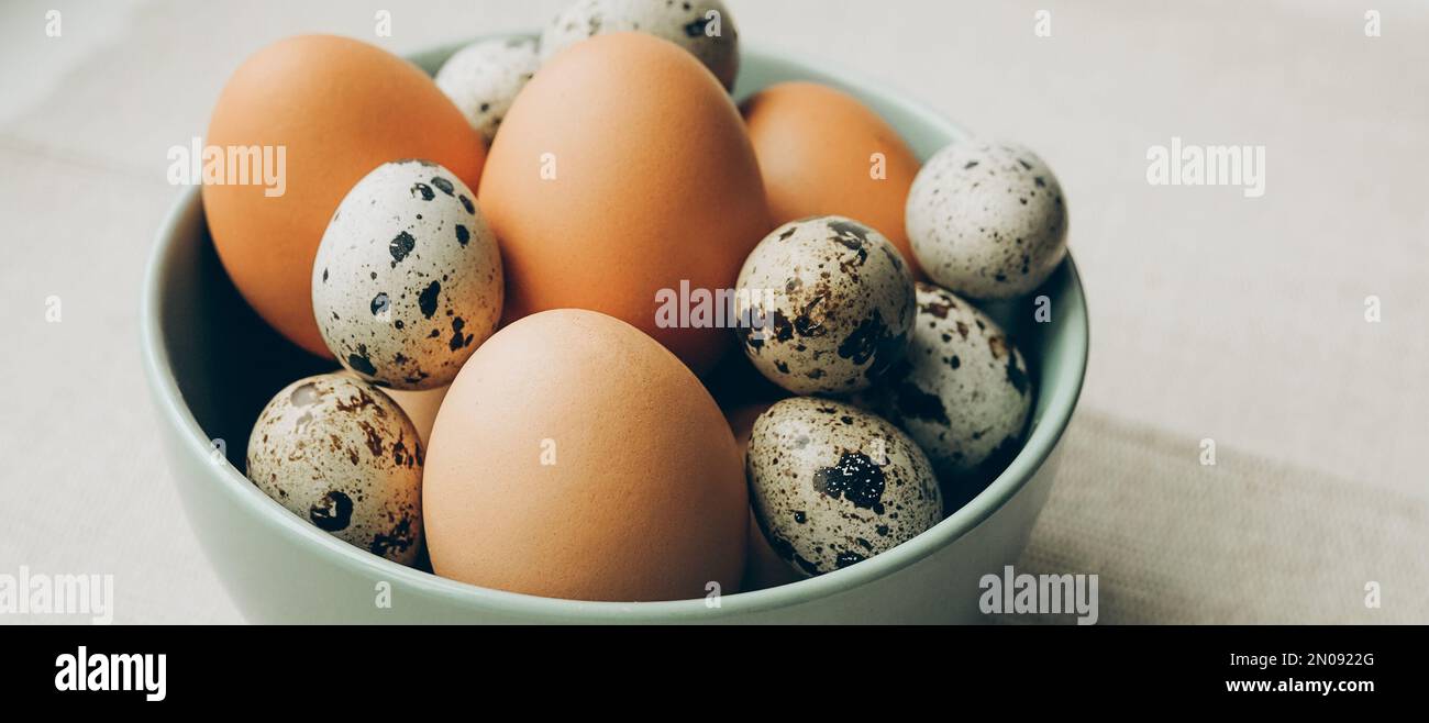 Easter eggs in the plate on beige background. Chicken and quail eggs catholic and orthodox easter holiday Stock Photo