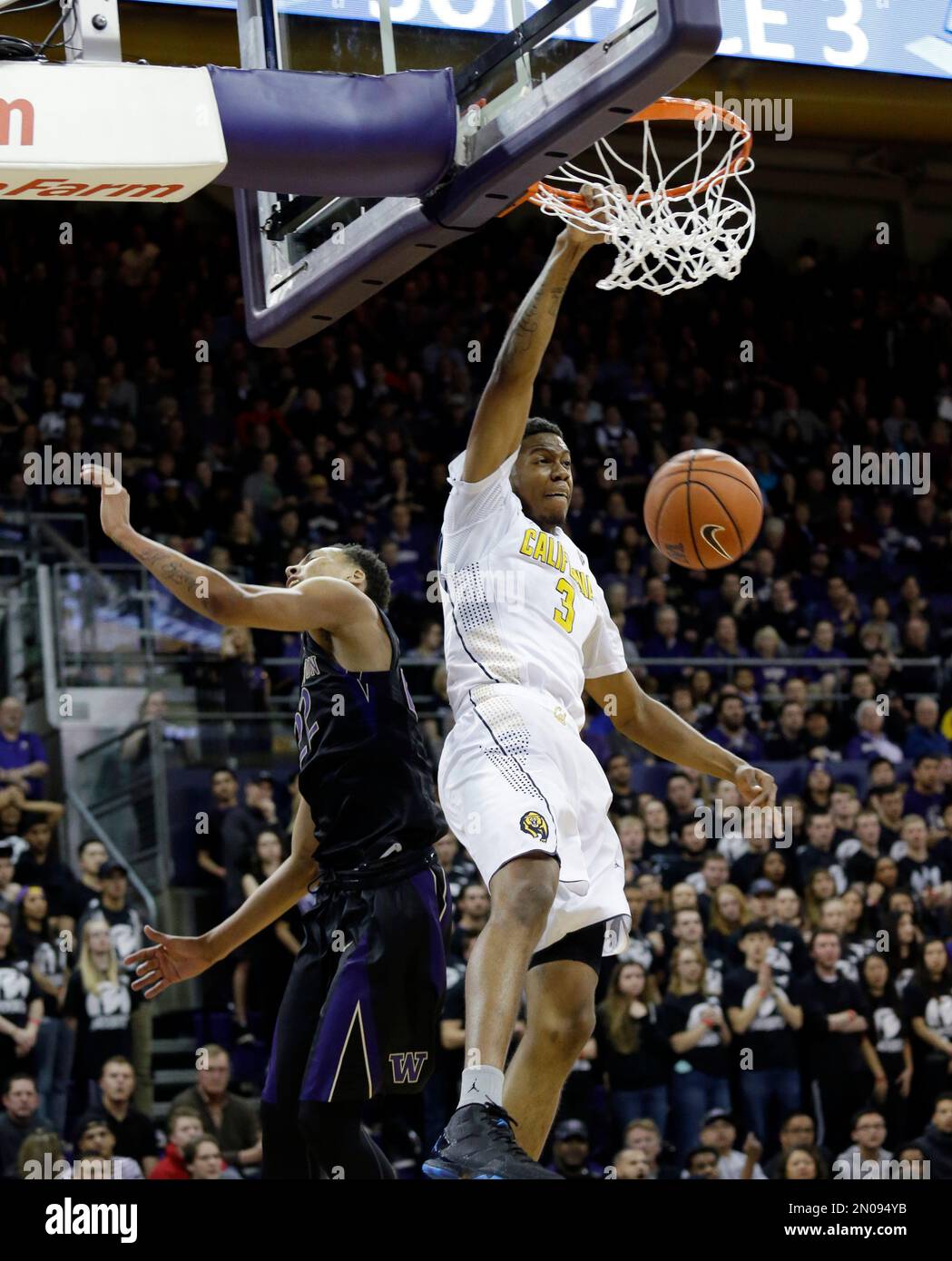 California's Tyrone Wallace (3) shoots past Washington's Dominic Green ...