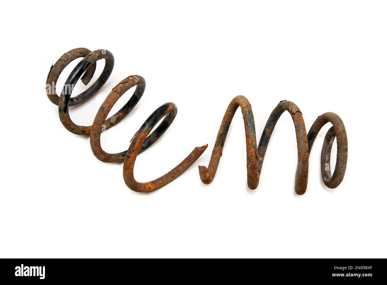 The old rusty broken coiled spring from the car suspension isolated in