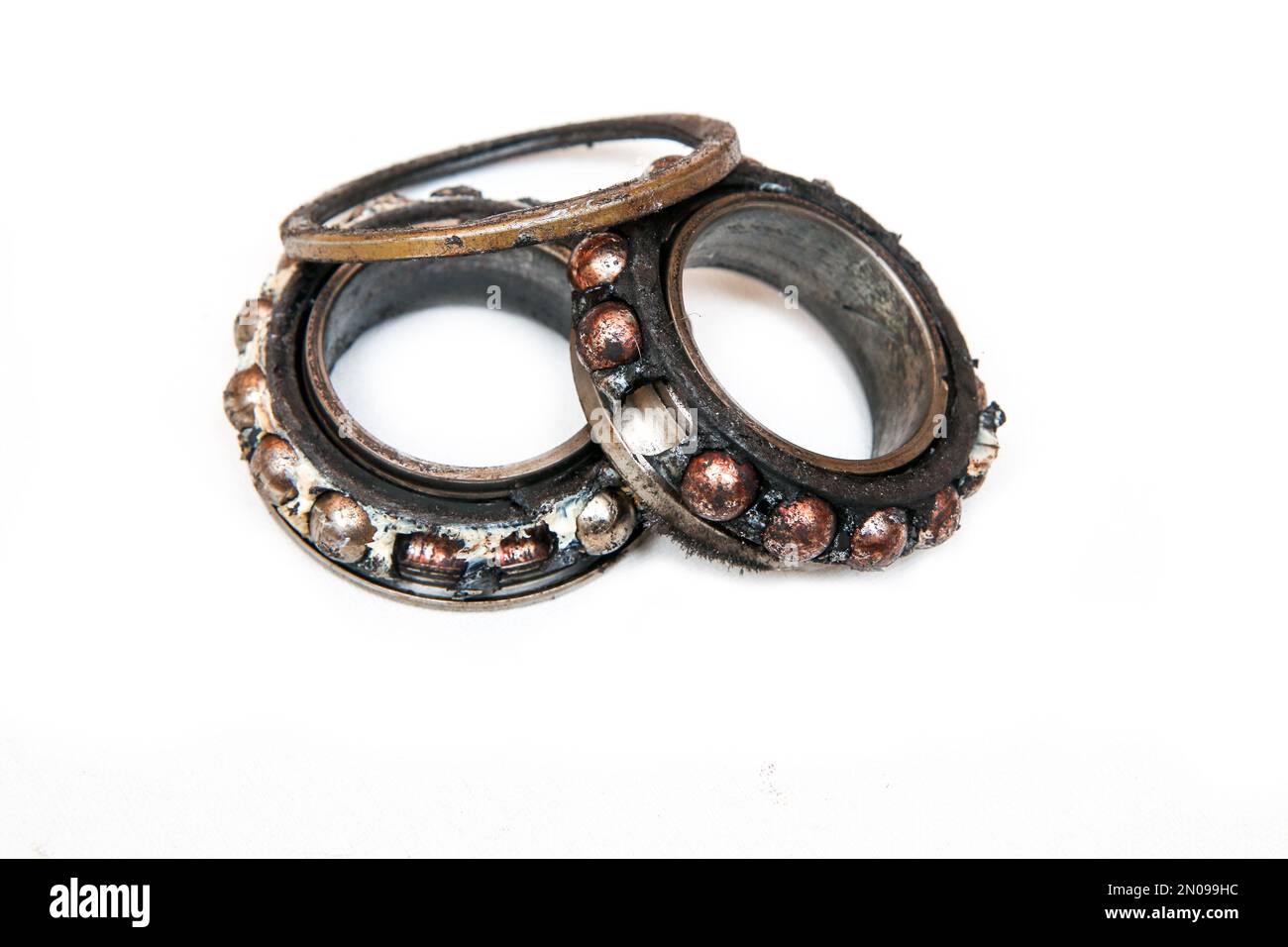 The old broken bearing, with the balls completely visible and a bit