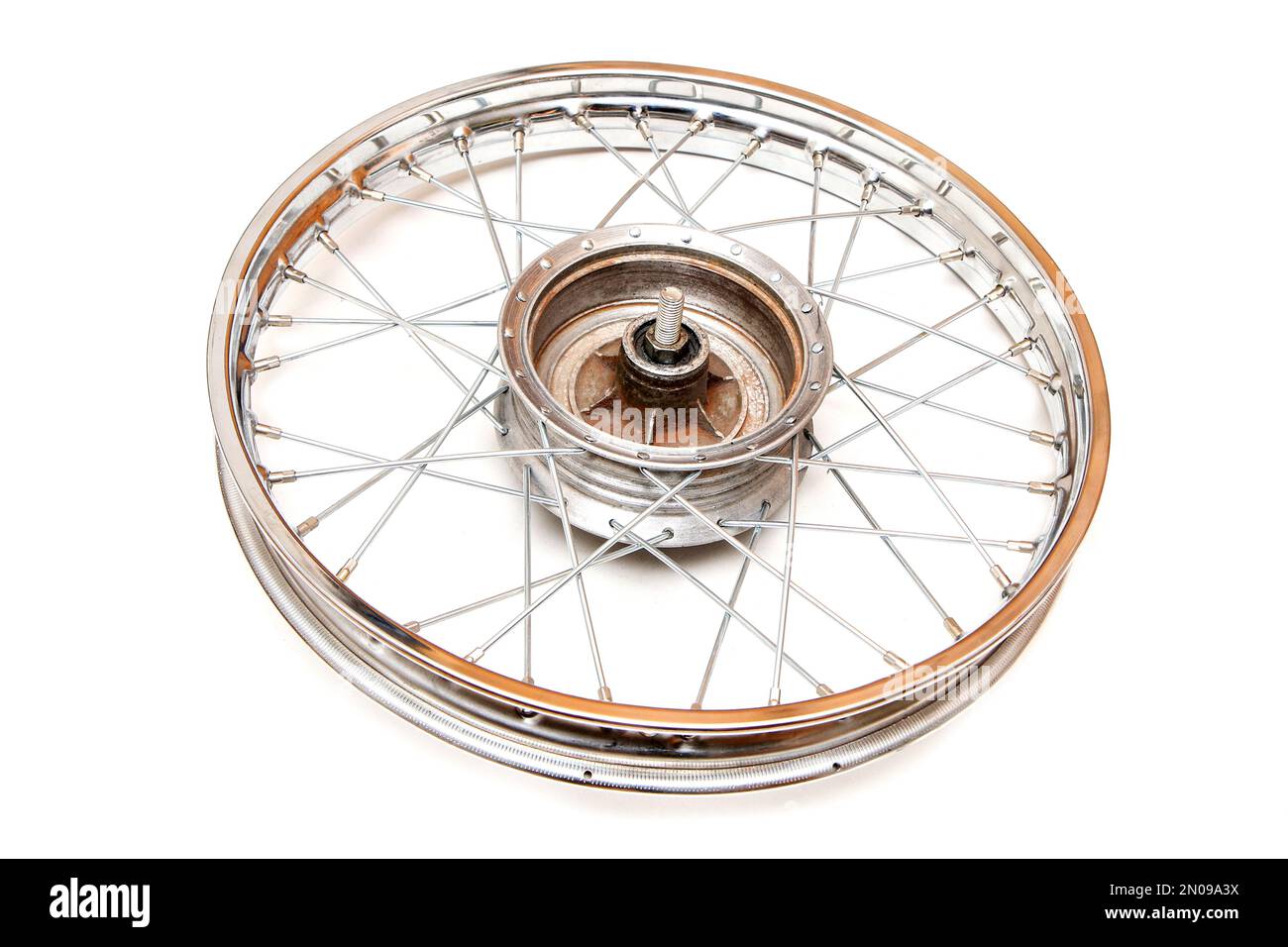 The shiny chrome rim from the old veteran motorbike with lacing. Isolated in a white background. Stock Photo