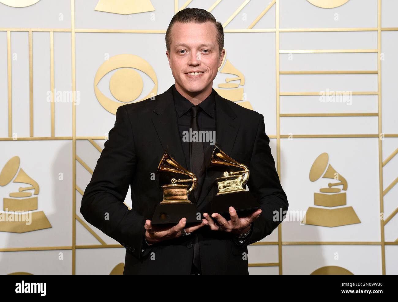 Jason Isbell poses in the press room with the awards for best americana
