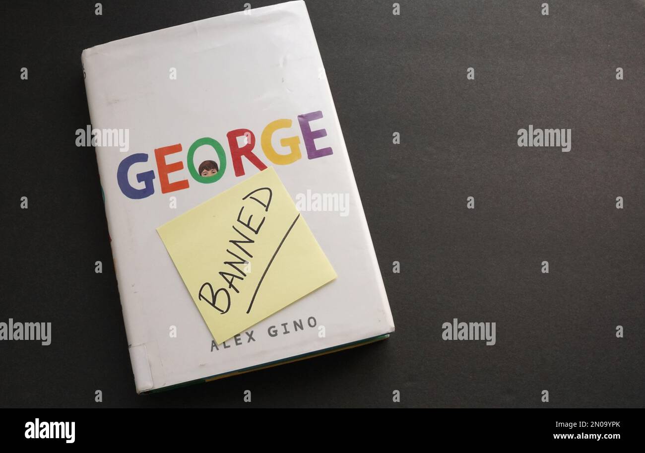 A copy of the book George by Alex Gino with a note saying 'banned.' The book has been placed on the banned book list at many schools and libraries. Stock Photo