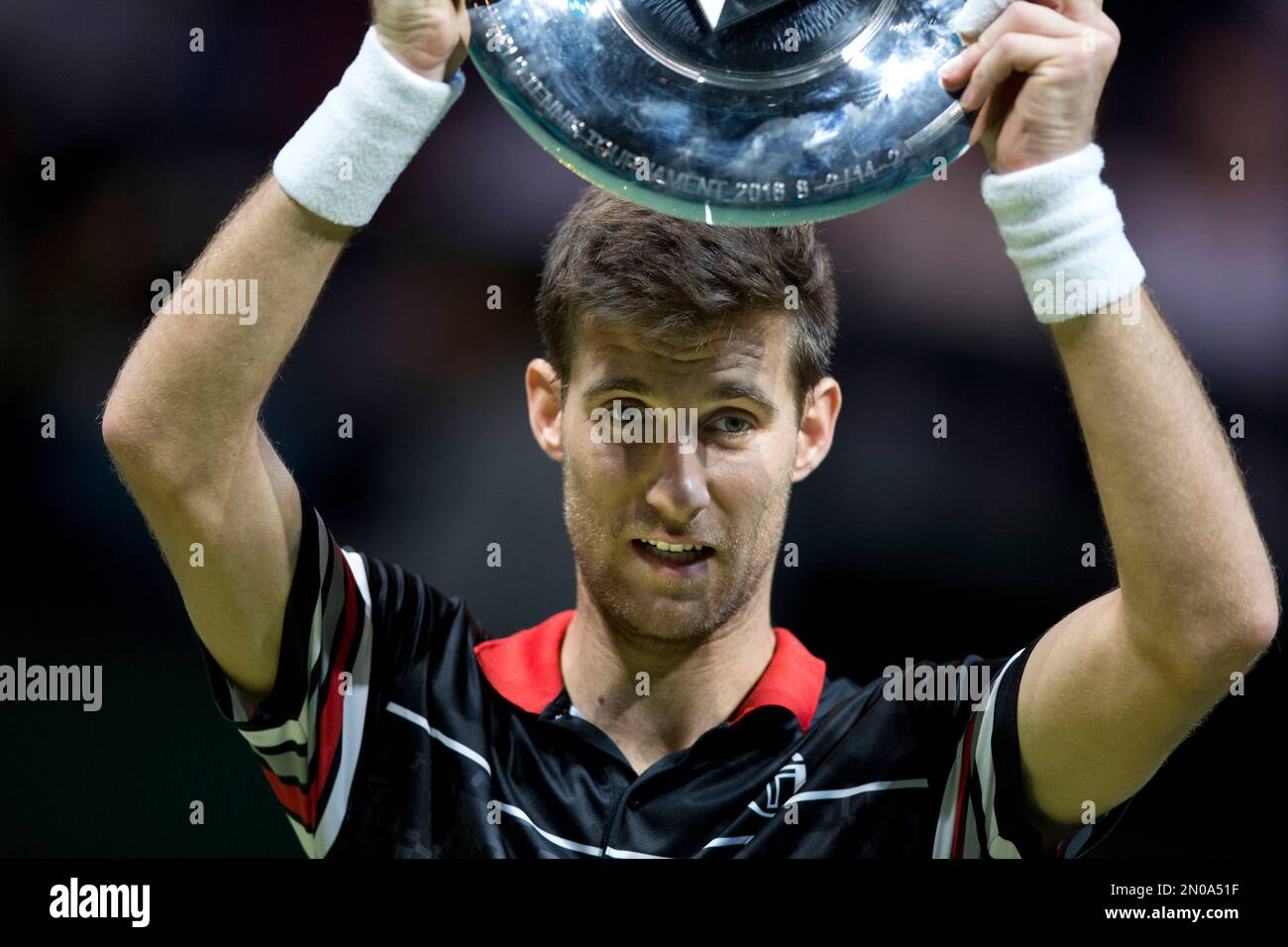 Slovakia's Martin Klizan holds the trophy after winning the ABN AMRO world  tennis tournament against France's Gael Monfils in three sets 6-7 (1-7),  6-3, 6-1, at the Ahoy arena in Rotterdam, Netherlands,