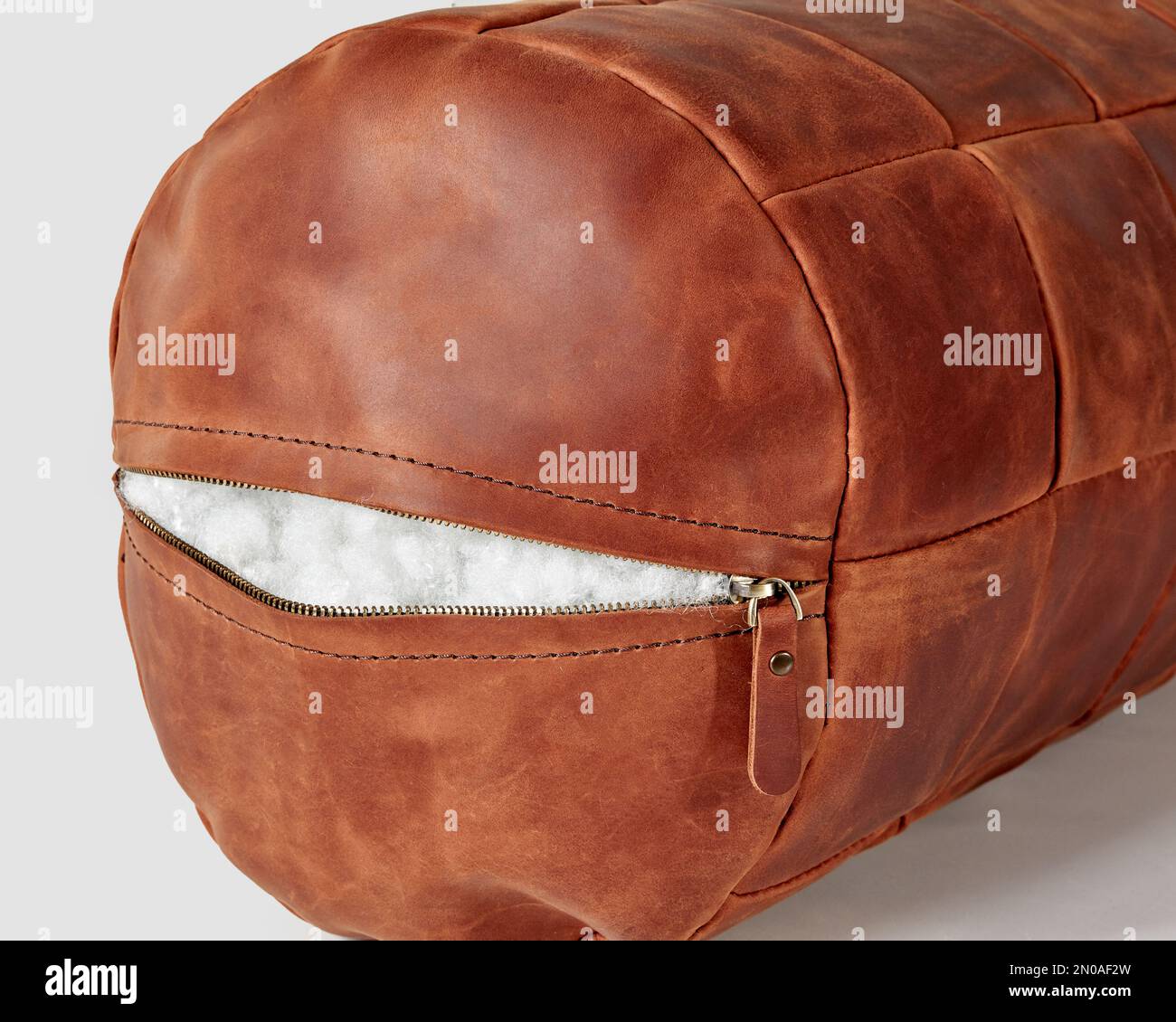 Coppercolored leather bolster pillow with zipper and holofiber filling