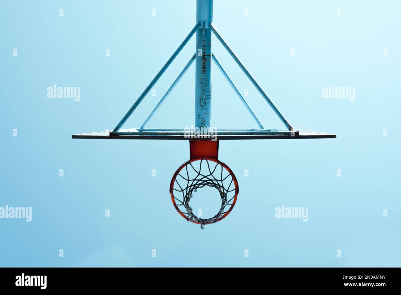 old abandoned street basketball hoop and blue sky background Stock Photo