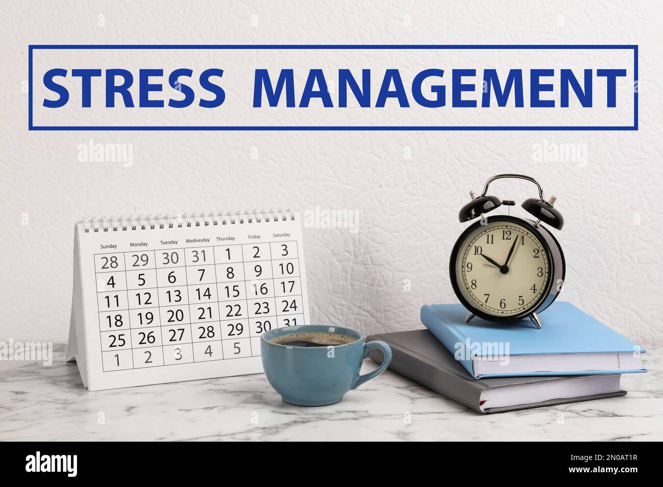 Text Stress Management over table with calendar, alarm clock, notebooks