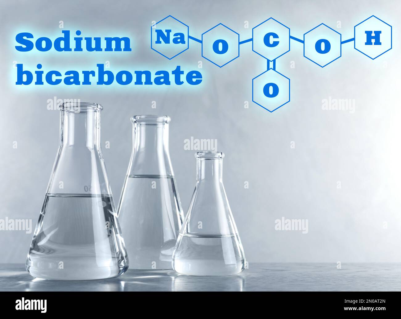 Text Sodium bicarbonate with soda formula and laboratory glassware on